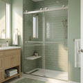 Bathroom with green tiled walls, a shower enclosure, and wooden vanity.