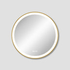 Round mirror with gold frame on a light gray background