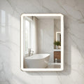 Bathroom with a illuminated LED mirror reflecting a bathtub and window.